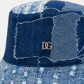 Close-up of a custom denim bucket hat with patchwork fabric and metal DG logo detail
