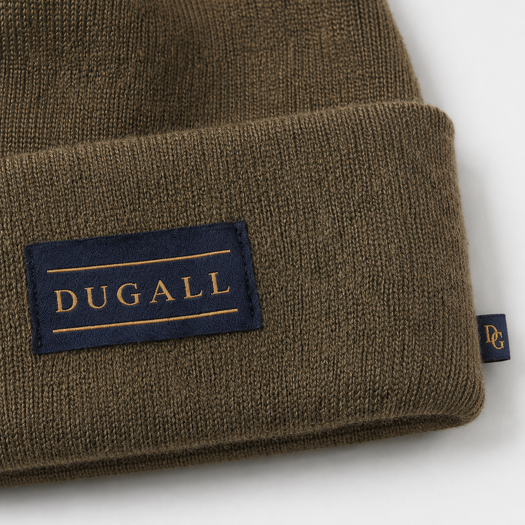 Close-up of custom patch label and side tag on an olive brown 100% acrylic knit beanie.
