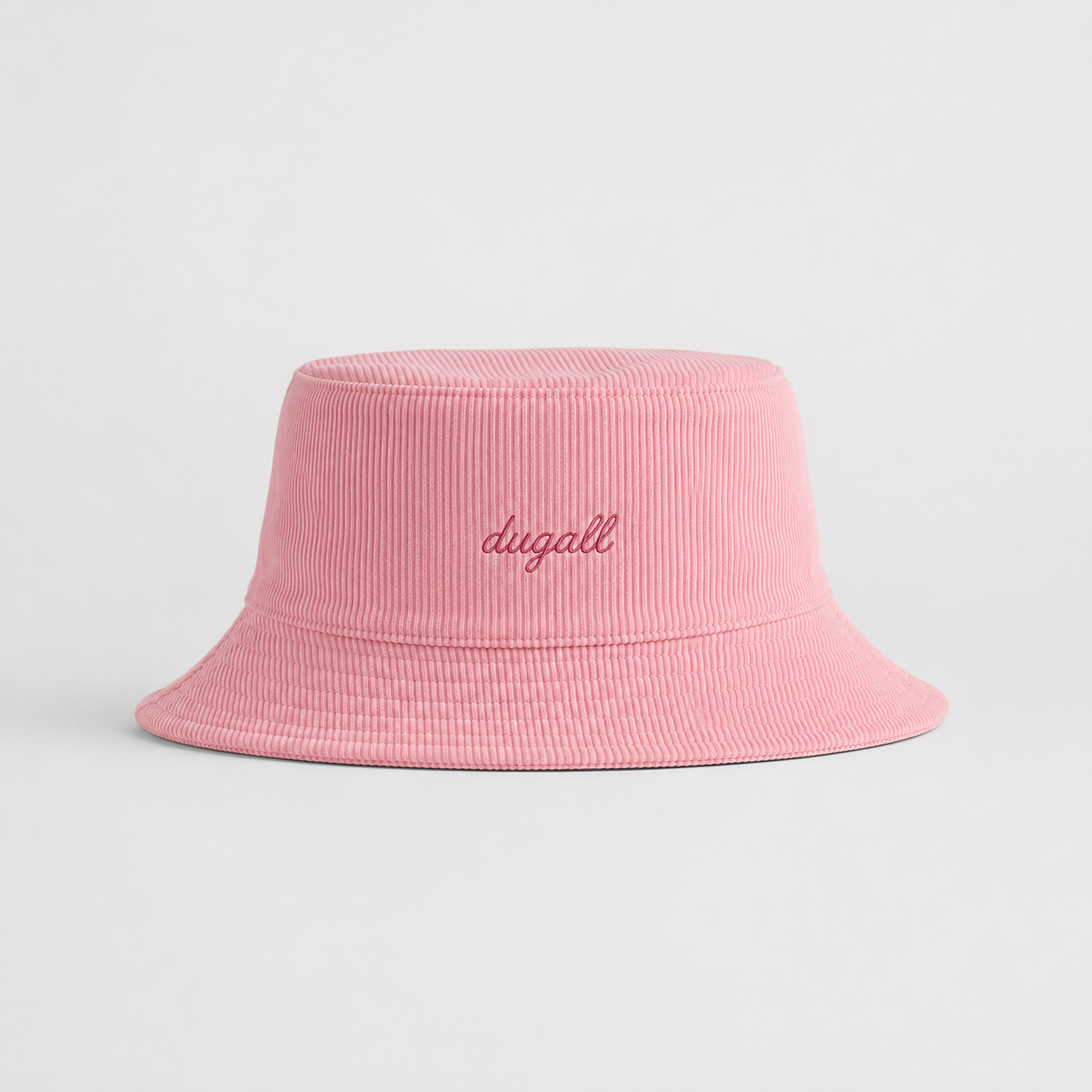 Front view of a soft pink 100% cotton bucket hat with minimalist embroidery logo.