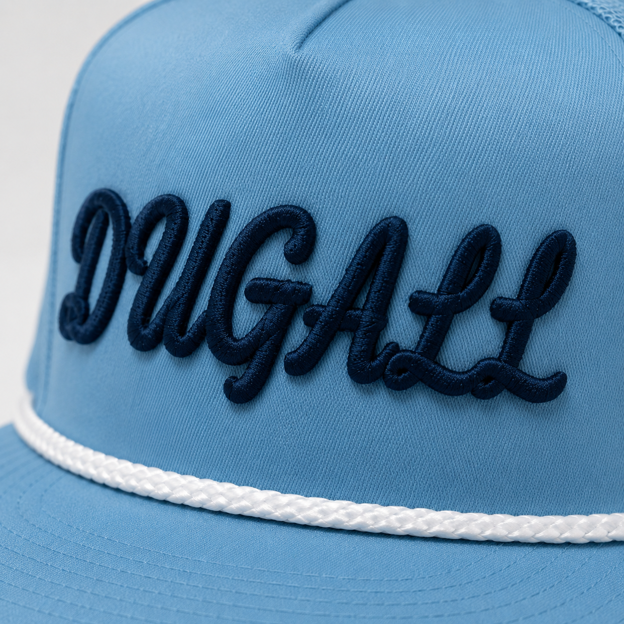Side view of sky blue mesh back trucker hat with raised 3D embroidery