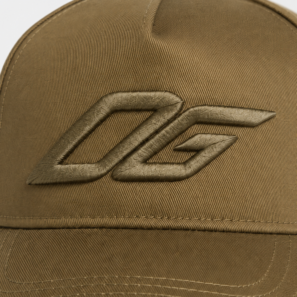 Close-up of raised 3D embroidery logo on an olive custom snapback hat