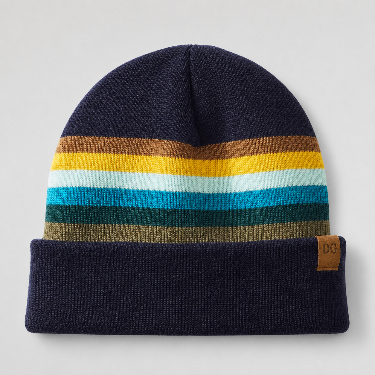Front view of a custom acrylic ski beanie with retro stripe design, navy cuff, and leather patch logo.