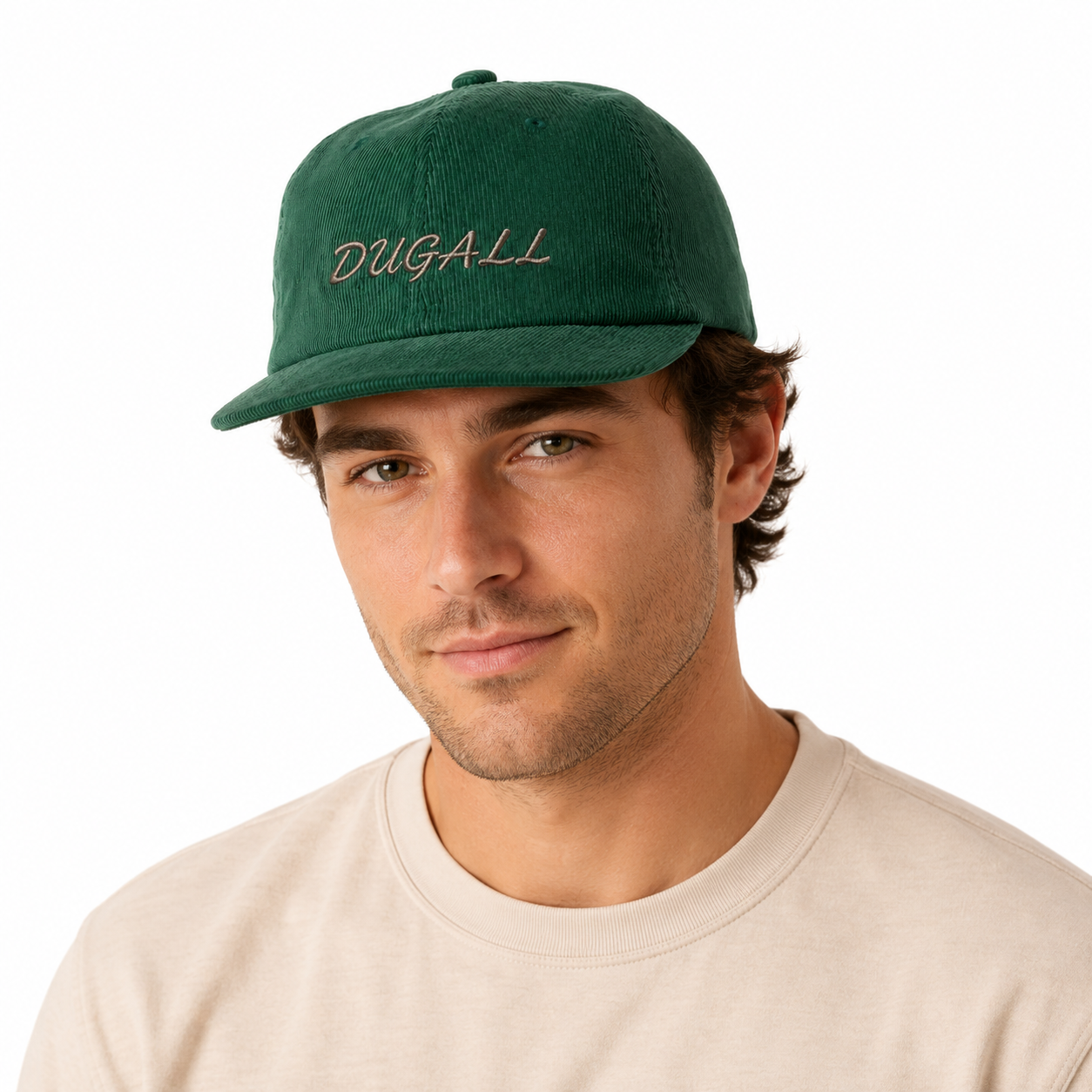 Male model wearing a green corduroy 5 panel baseball cap with custom embroidered logo.
