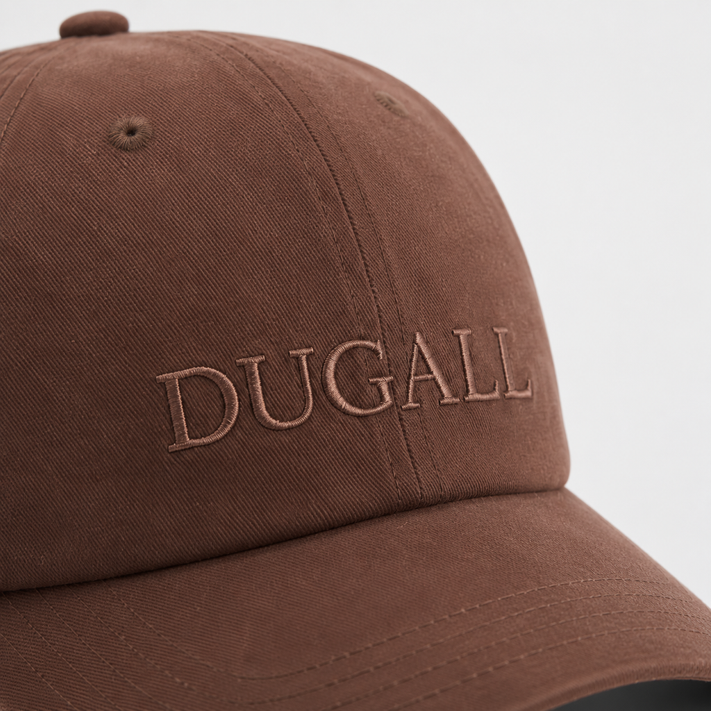 Close-up of tone-on-tone embroidered logo on a brown 100% cotton custom snapback hat.