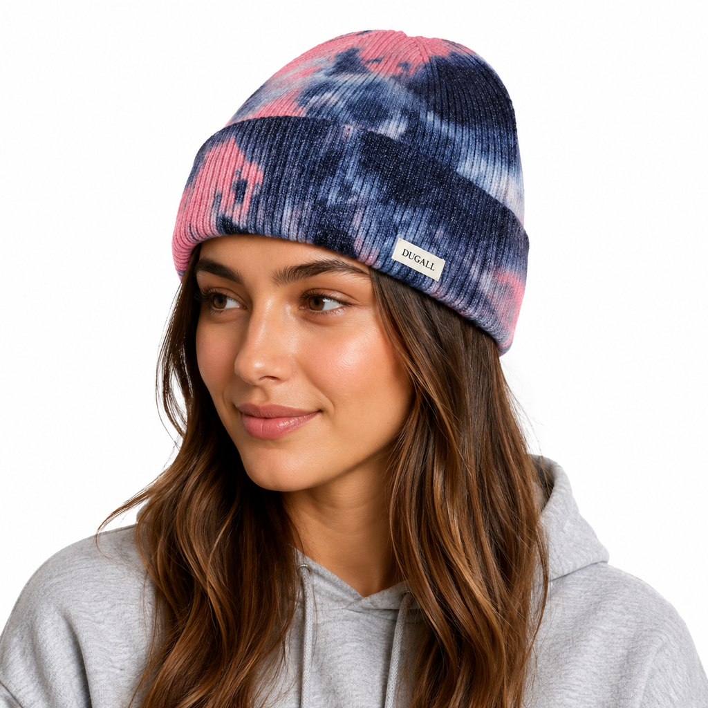Woman wearing a pink and navy tie dye knit beanie with custom DUGALL label on the cuff.