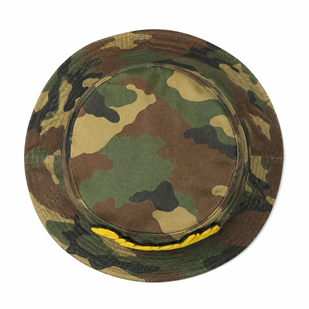 Top view of a custom vintage camouflage bucket hat with washed cotton fabric and chenille logo detail.