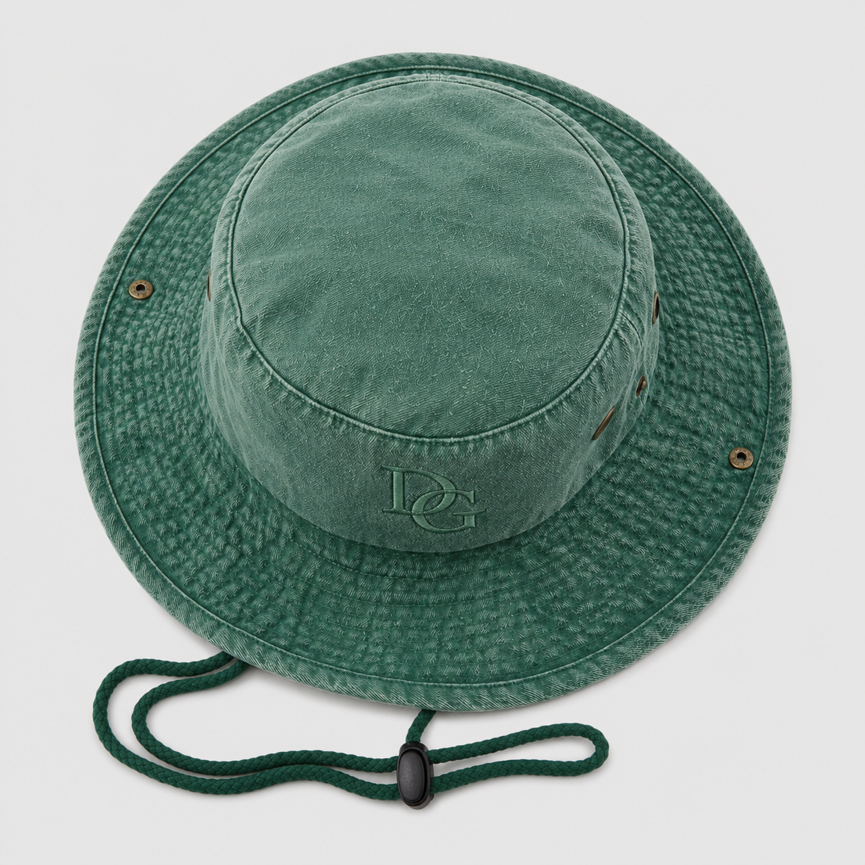 Top view of a custom green cotton bucket hat with embroidered logo and chin cord detail
