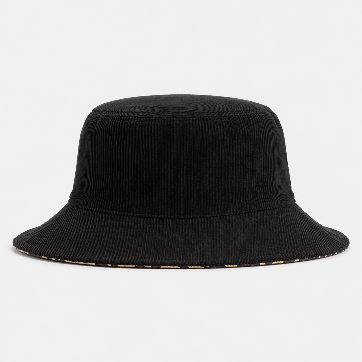 Reversible bucket hat showing leopard print outer side and black inner side for two-sided wear