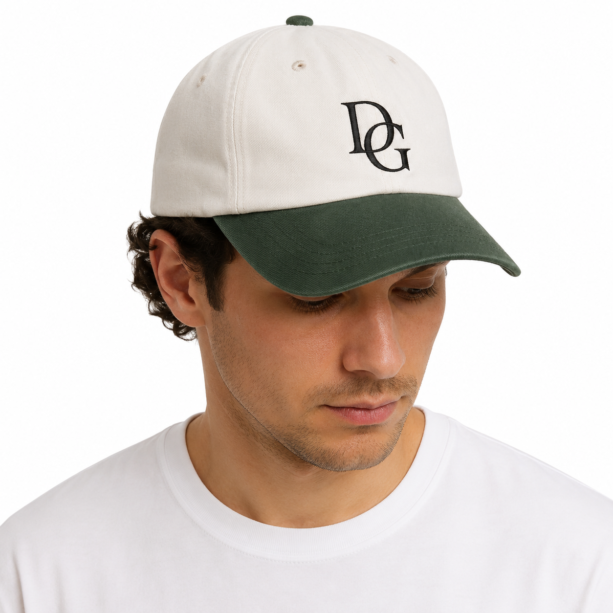 Male model wearing a two tone custom dad hat with cotton crown, faux suede brim, and black embroidered logo.