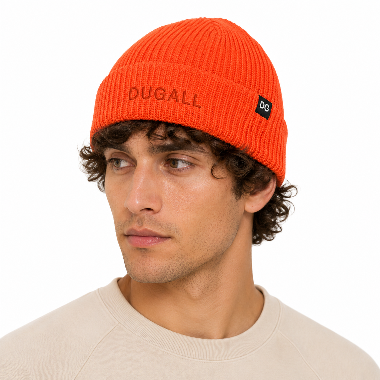 Male model wearing a bright orange custom short beanie made from acrylic yarn with embroidered branding and side label detail