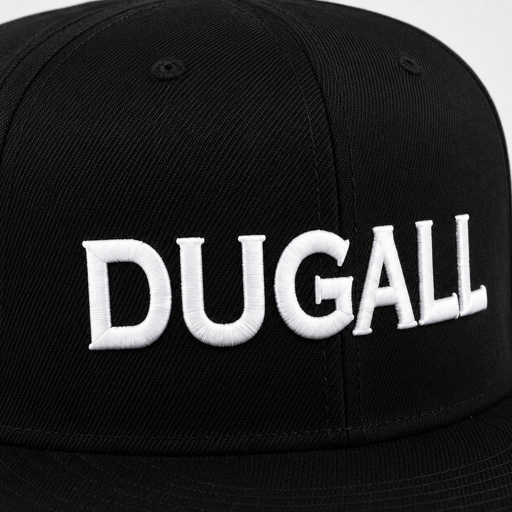 Close-up of white custom embroidered logo on a black cotton snapback hat with flat brim.