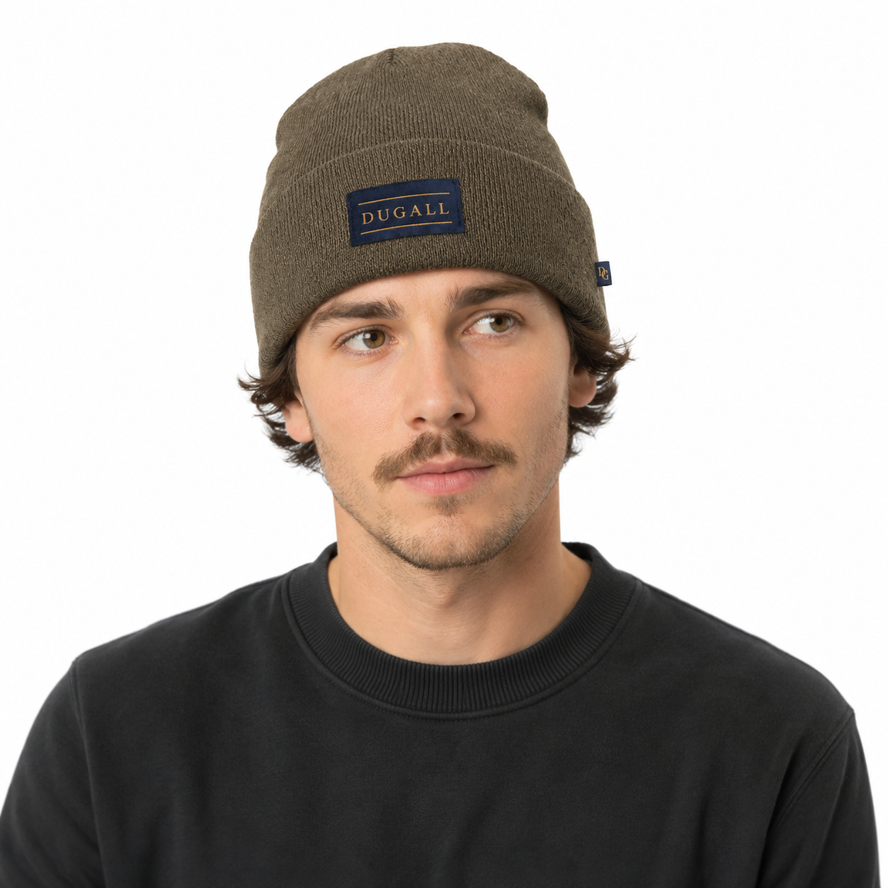 Male model wearing a custom olive brown acrylic beanie with front patch label and side tag detail.