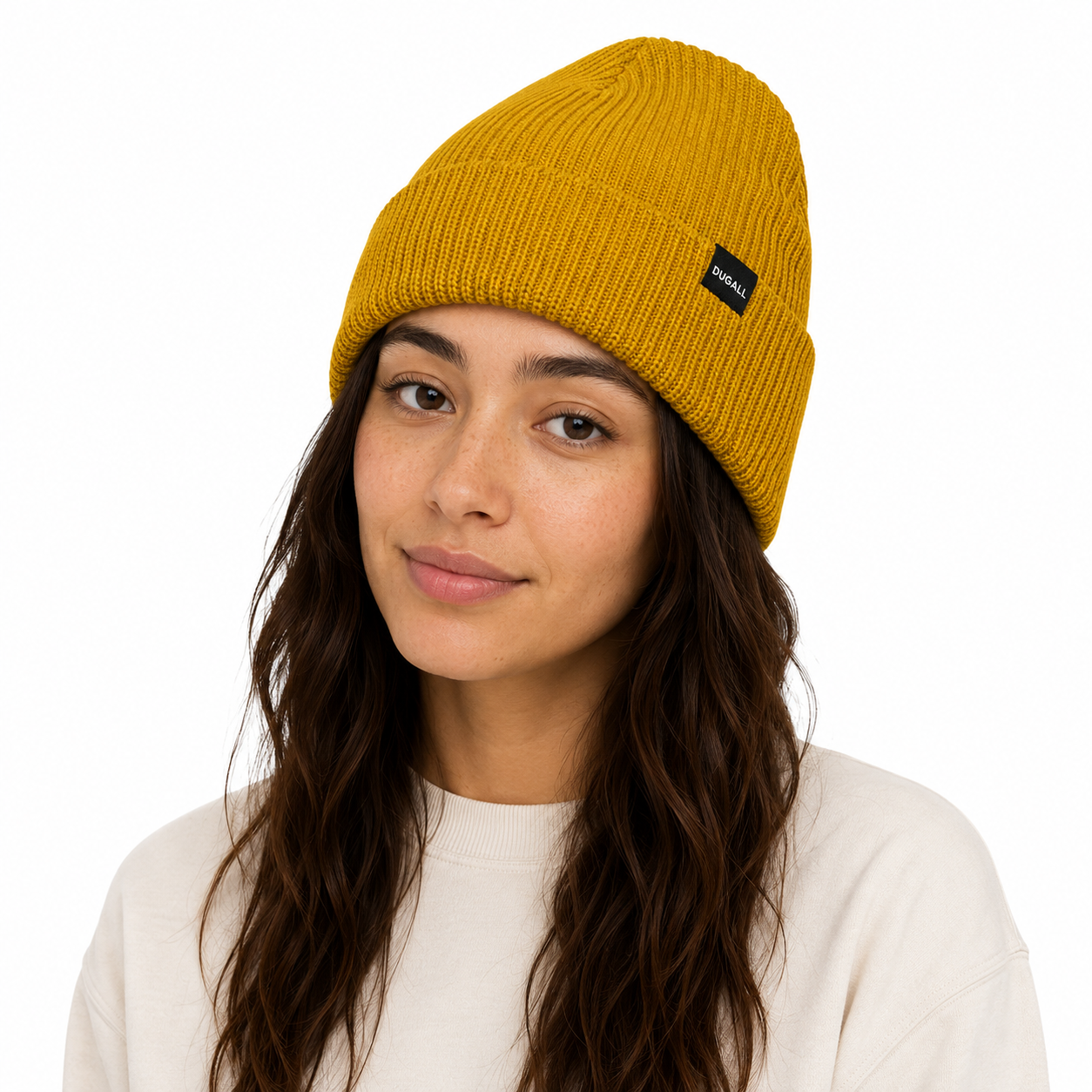 Female model wearing a mustard yellow ribbed acrylic beanie with custom woven label logo