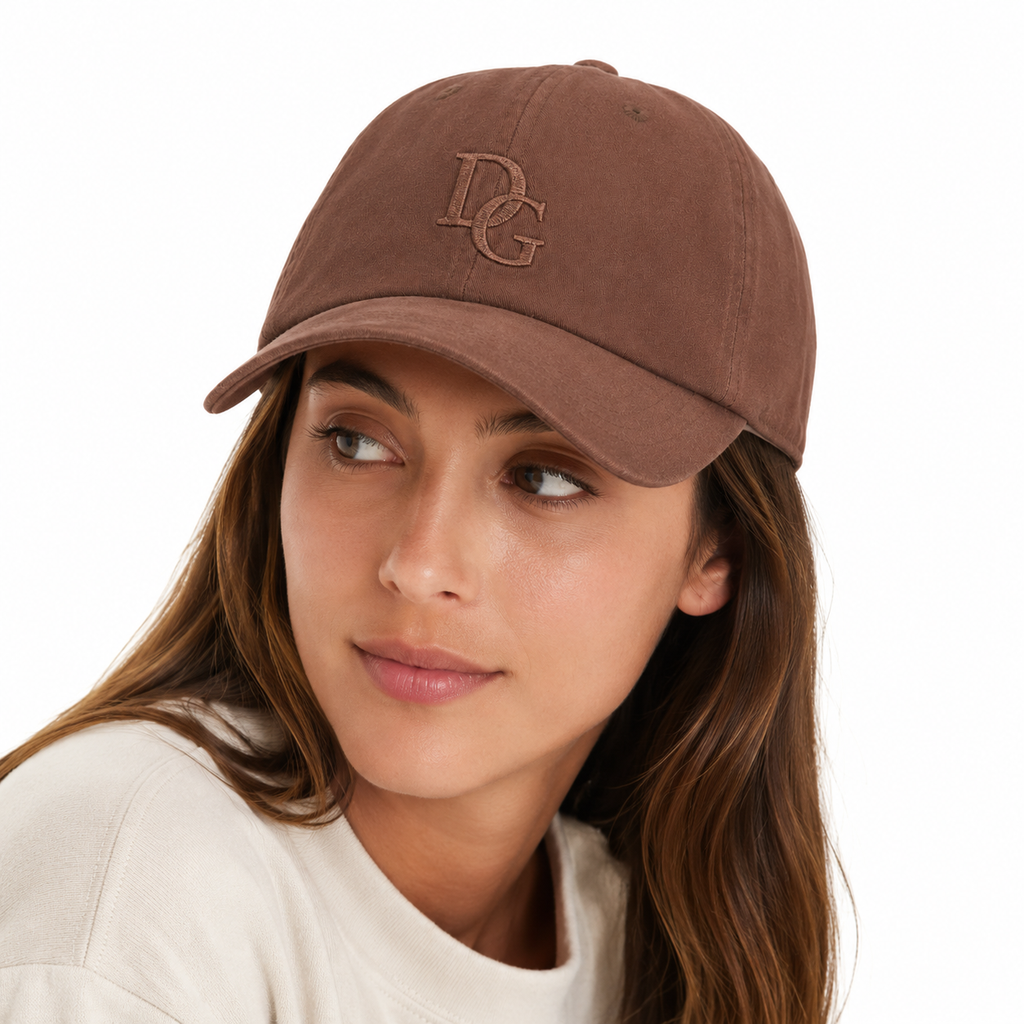 Female model wearing a coffee brown washed cotton dad hat with subtle custom embroidery logo.