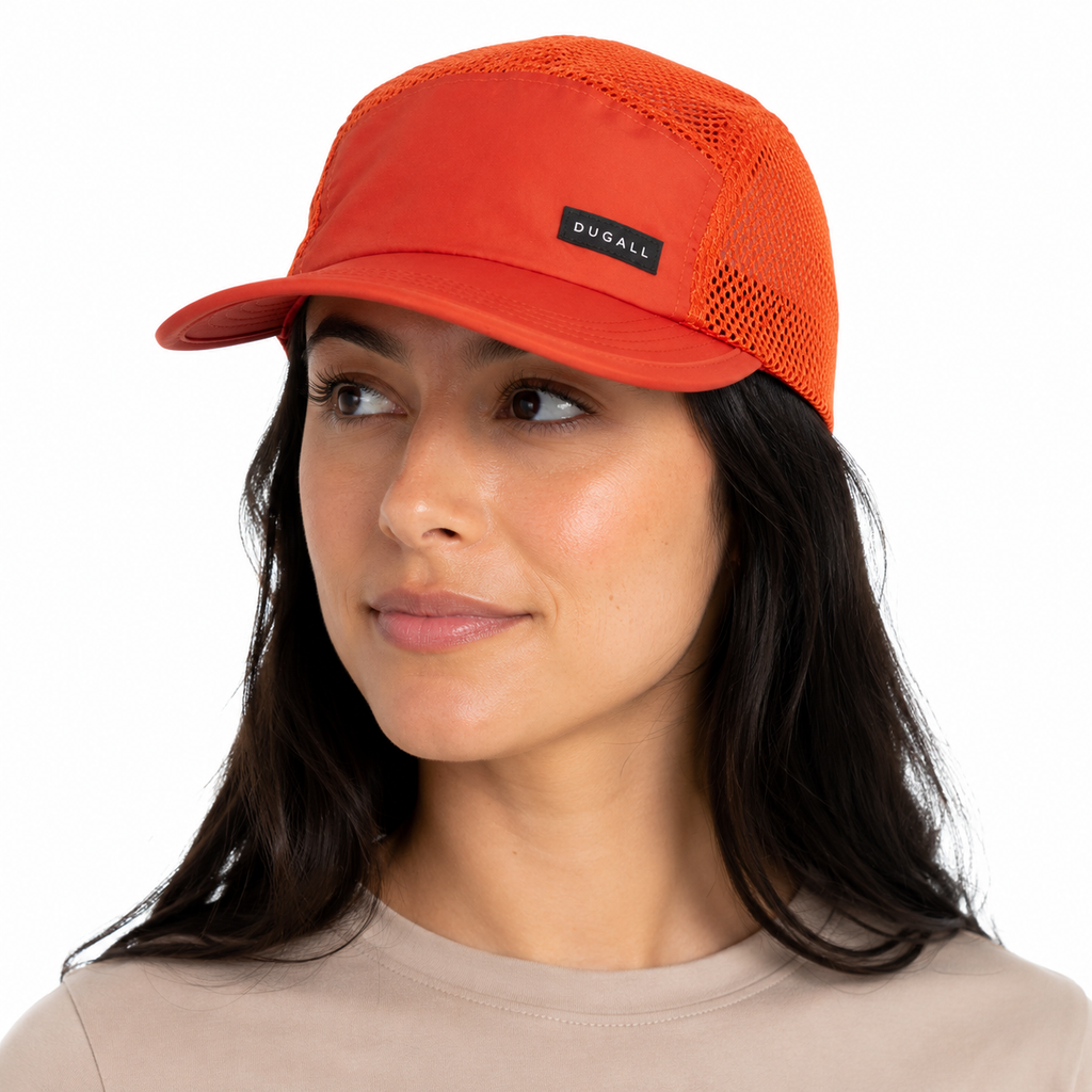 Woman wearing a custom orange 5 panel nylon mesh cap with breathable summer-ready design
