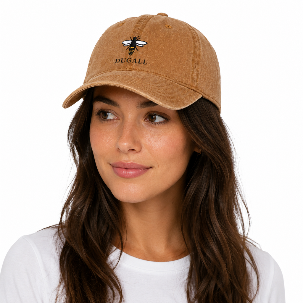 Female model wearing a honey brown washed cotton dad hat with custom bee embroidery logo.