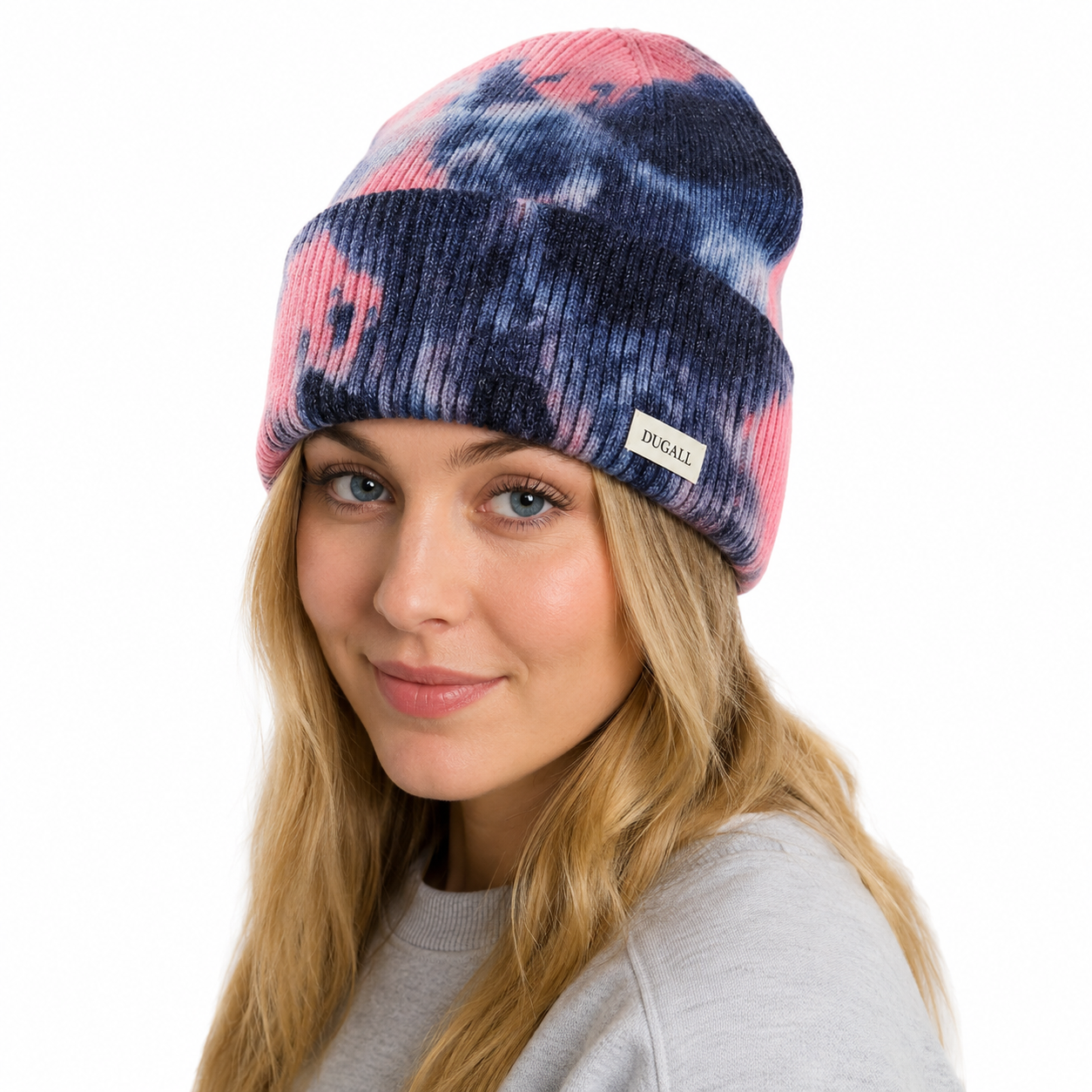 Female model wearing a colorful tie dye acrylic beanie with custom logo label.