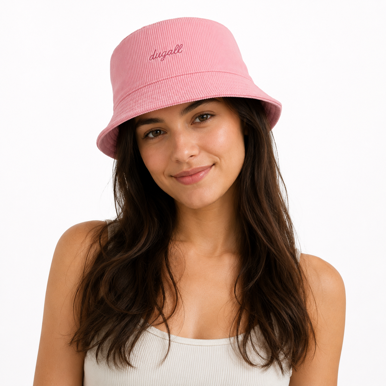 Woman wearing a pink embroidered cotton bucket hat on a clean white background.