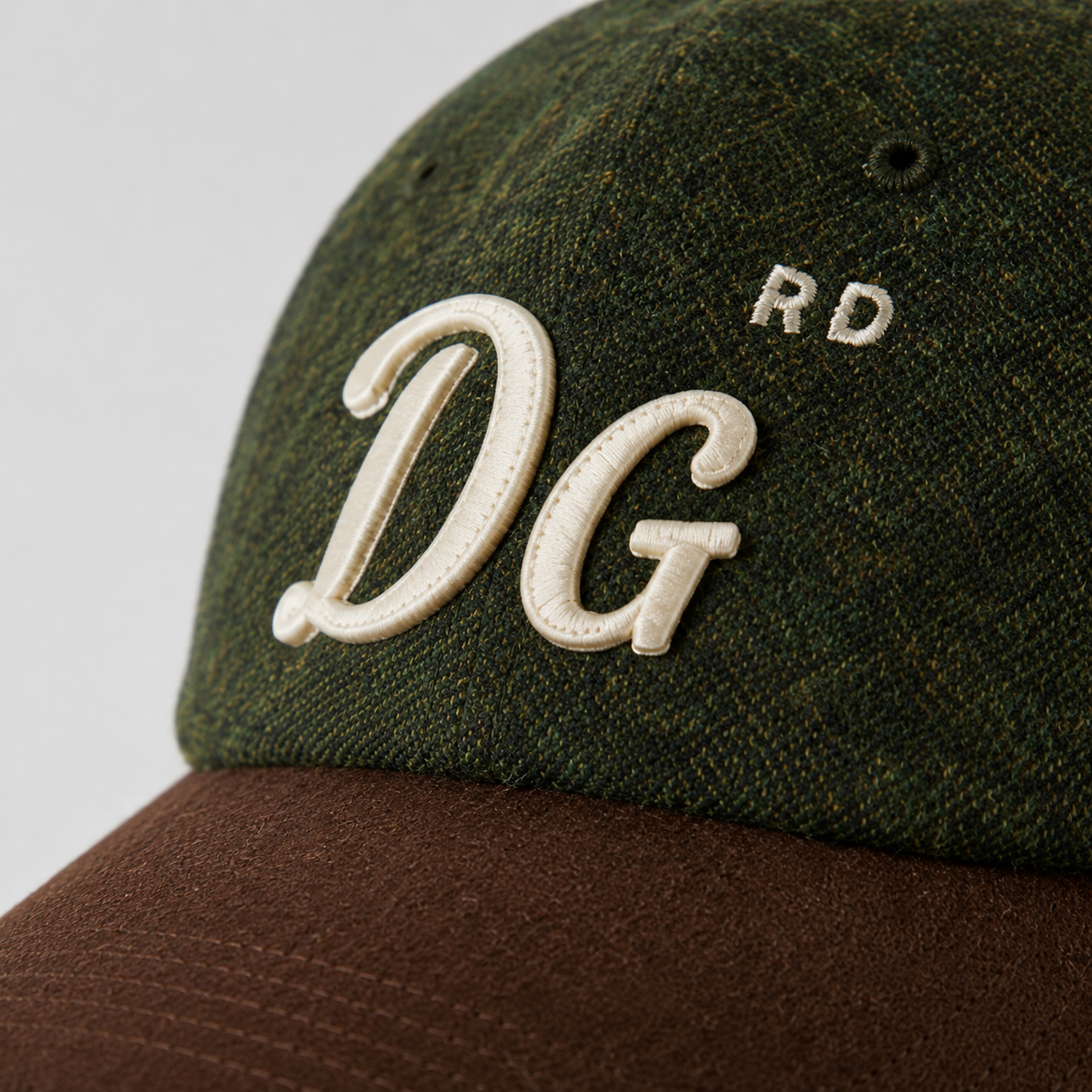 Close-up of custom embroidered logo on a wool dad hat with cotton brim.